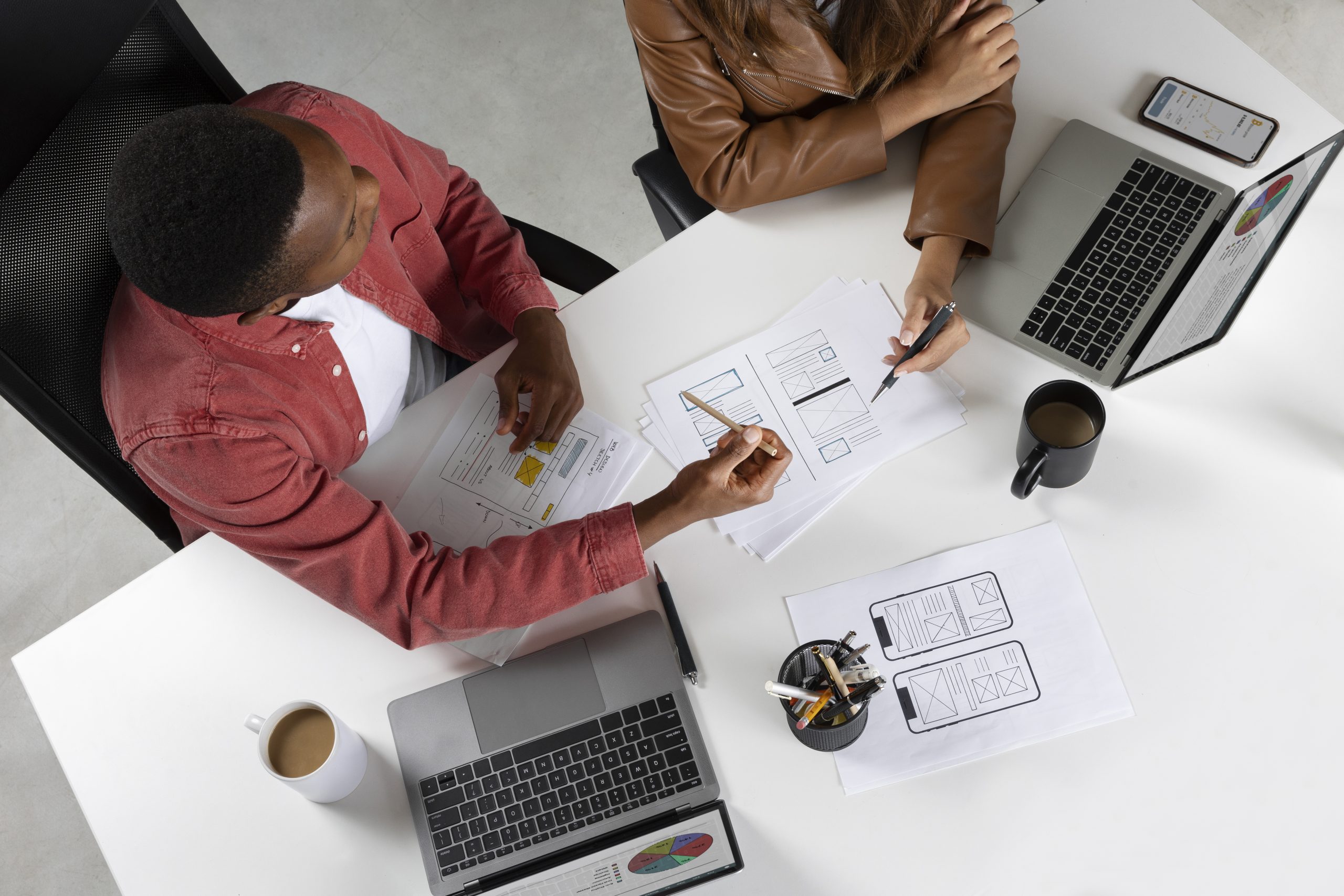 top-view-people-working-with-laptops-scaled (1)